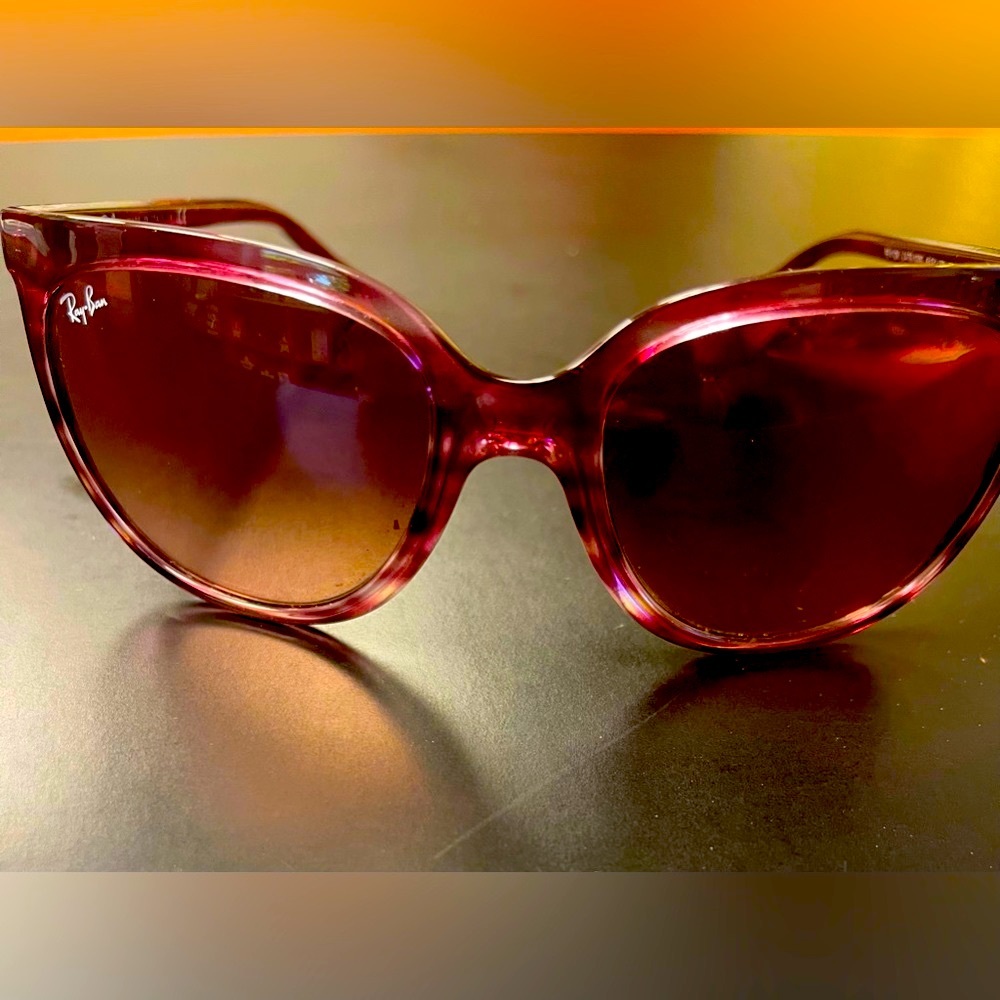 Ray Ban sunglasses with a pink/purple tint
